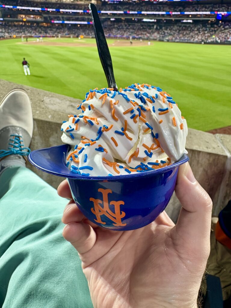 Vanilla ice cream in a Mets plastic helmet with Mets sprinkles. Juan Soto is in the background.